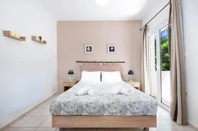 a bedroom with a bed with two towels on it at Aptera Beach Apartment in Kato Daratso