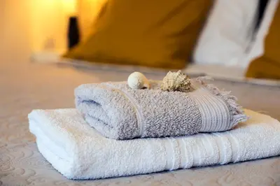 a stack of towels with a seashell on top at Coco Studio in Chania Town