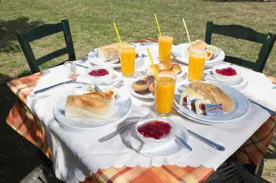 a table with plates of food and drinks on it at Kalami Rooms in Falasarna