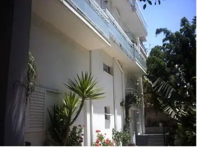 a white building with plants in front of it at Diana Rooms in Chania Town