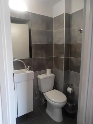 a bathroom with a toilet and a sink at Diana Rooms in Chania Town