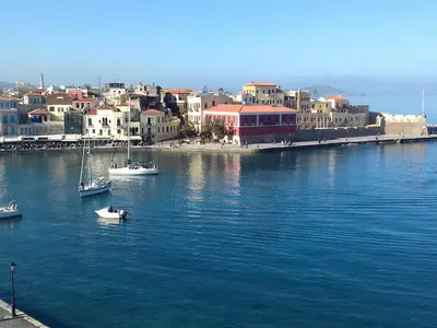 a group of boats in a body of water with buildings at Diana Rooms in Chania Town