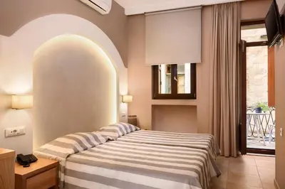 a bedroom with a bed and a window at Morfeas Hotel in Chania Town