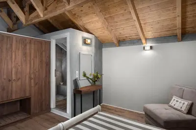 a living room with a couch and wooden ceilings at Morfeas Hotel in Chania Town