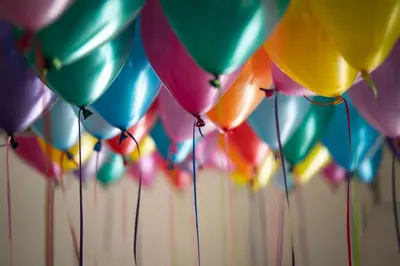 a bunch of colorful balloons are hanging up at Pegasus Hotel in Stalos