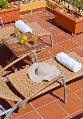 a table and chairs with a hat on it on a patio at Kores Boutique Houses in Chania Town