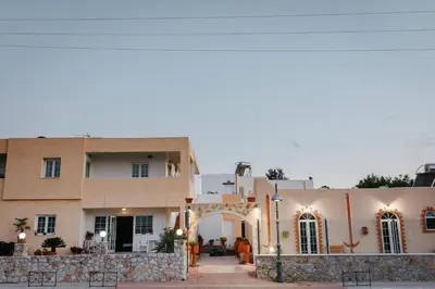 a building with an arch in front of it at Konaki Apartments in Maleme