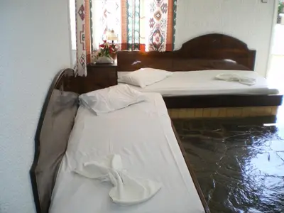 two beds with white shoes sitting on top of them at Konaki Apartments in Maleme