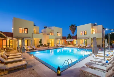 a swimming pool in front of a villa at Daphnis Villas in Maleme