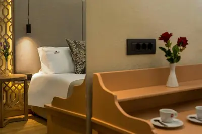 a hotel room with a bed and a vase with flowers at ELG Contessa Boutique Hotel in Chania Town