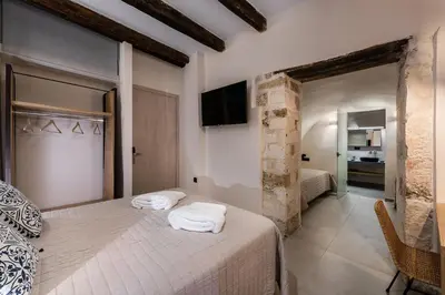 a bedroom with two beds with white towels on them at Aoria Estate Old Port in Chania Town