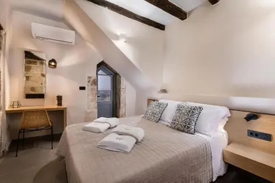 a bedroom with a bed with two towels on it at Aoria Estate Old Port in Chania Town