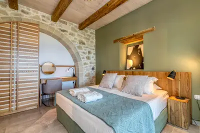 a bedroom with a large bed in a room at Aspalathos Falassarna Villas in Falasarna