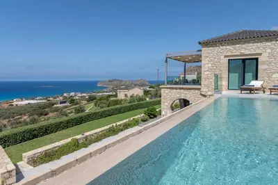 a villa with a swimming pool with a view of the ocean at Aspalathos Falassarna Villas in Falasarna