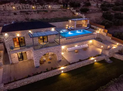 an aerial view of a house with a swimming pool at night at Aspalathos Falassarna Villas in Falasarna