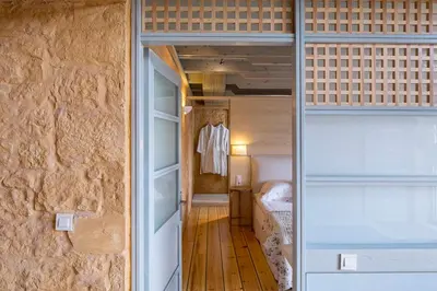 a small room with a bed and a dressing room at Olea Villas - Infinity Pool, Hot Tub, Sea Views in Marathi