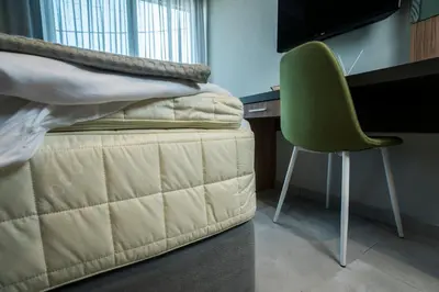 a bedroom with a bed and a desk and a green chair at Mediterranean Luxury Apartment in Chania Town