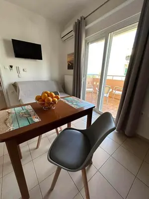 a room with a table with a bowl of fruit on it at Fougaro Apartments in Chania Town