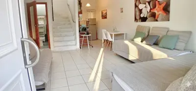 a living room with a couch and a table at Marianna Apartments in Almirida