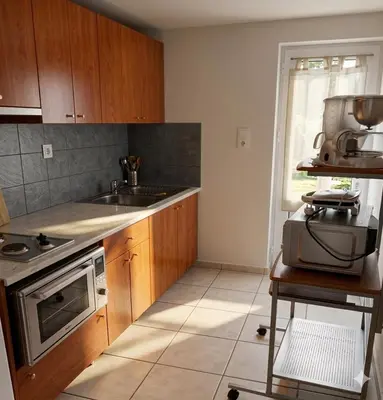 a kitchen with a sink and a stove at Marianna Apartments in Almirida