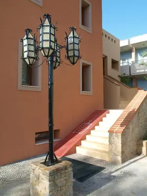 a lamp post in front of a building with stairs at Mylos Hotel Apartments in Plataniás