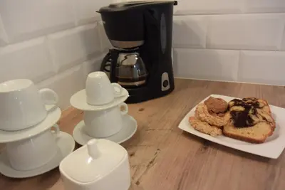 a table with coffee cups and a plate of food at Agapi Suites in Chania Town