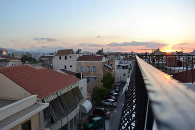 a view of a city at sunset from a balcony at Agapi Suites in Chania Town