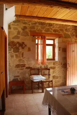 a room with a table and chairs and a window at Golden Sun Apartments in Falasarna