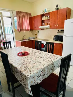 a kitchen with a table with a red plate on it at Nea Chora cozy apartment close to the beach in Chania Town