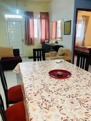 a dining room table with a plate on top of it at Nea Chora cozy apartment close to the beach in Chania Town