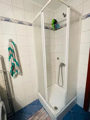 a shower with a glass door in a bathroom at Nea Chora cozy apartment close to the beach in Chania Town