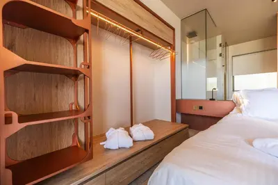 a bedroom with a bed and a mirror at Oniros Residences in Souda