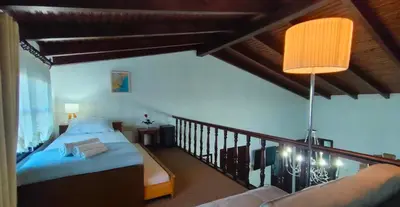 a bedroom with a bed and a balcony at Diktamo House in Agia Marina Nea Kydonias