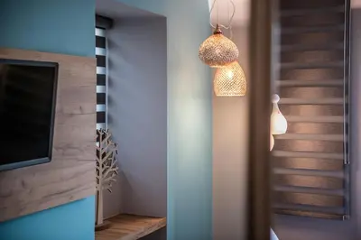 a room with a television and a pendant light at Ciel Collection Suites in Chania Town