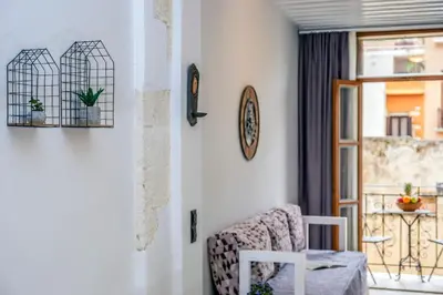 a living room with a chair and a window at Vereniki Suites Chania in Chania Town