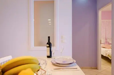 a table with a bottle of wine and a bunch of bananas at Gina's home in Kolymvari