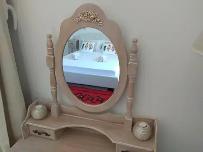 a mirror on a wooden stand in a bedroom at PALACE Mountain view in Megála Khoráfia