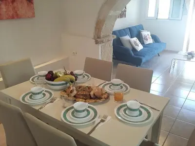 a table with a bowl of fruit on top of it at PALACE Mountain view in Megála Khoráfia