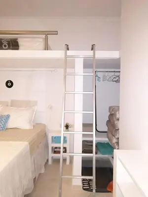 a bedroom with a bunk bed and a ladder at Zamboli in Chania Town