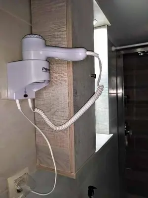 a bathroom with a white blow dryer on the wall at Zamboli in Chania Town