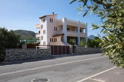 a white building on the side of a road at Georgia Sunset in Trákhilos