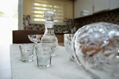 a bottle of water and glasses on a table at Georgia Sunset in Trákhilos