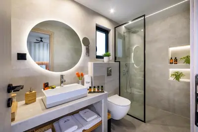 a bathroom with a sink and a toilet and a mirror at Vintage City Apartments in Chania Town