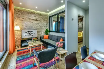 a living room with a couch and a brick wall at Vintage City Apartments in Chania Town