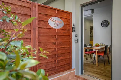 a wooden wall with a sign for a restaurant at Vintage City Apartments in Chania Town