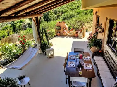 a patio with a table and chairs on a patio at Thymes traditional house in Loúlos