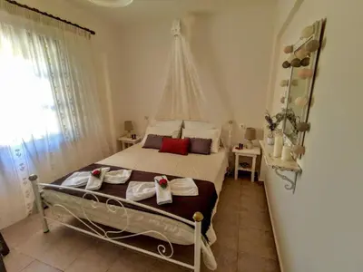 a bedroom with a bed with towels on it at Thymes traditional house in Loúlos