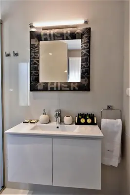 a bathroom with a white sink and a mirror at Villa Evangelia in Chania Town