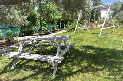 a picnic table and a bench in the grass at Villa Evangelia in Chania Town