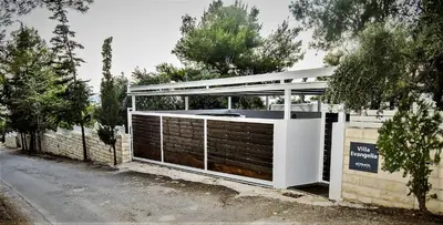 a building with a gate and a fence at Villa Evangelia in Chania Town